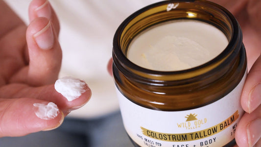 Beef tallow for hair: a fingertip of whipped Wild Gold Tallow balm beside an open jar